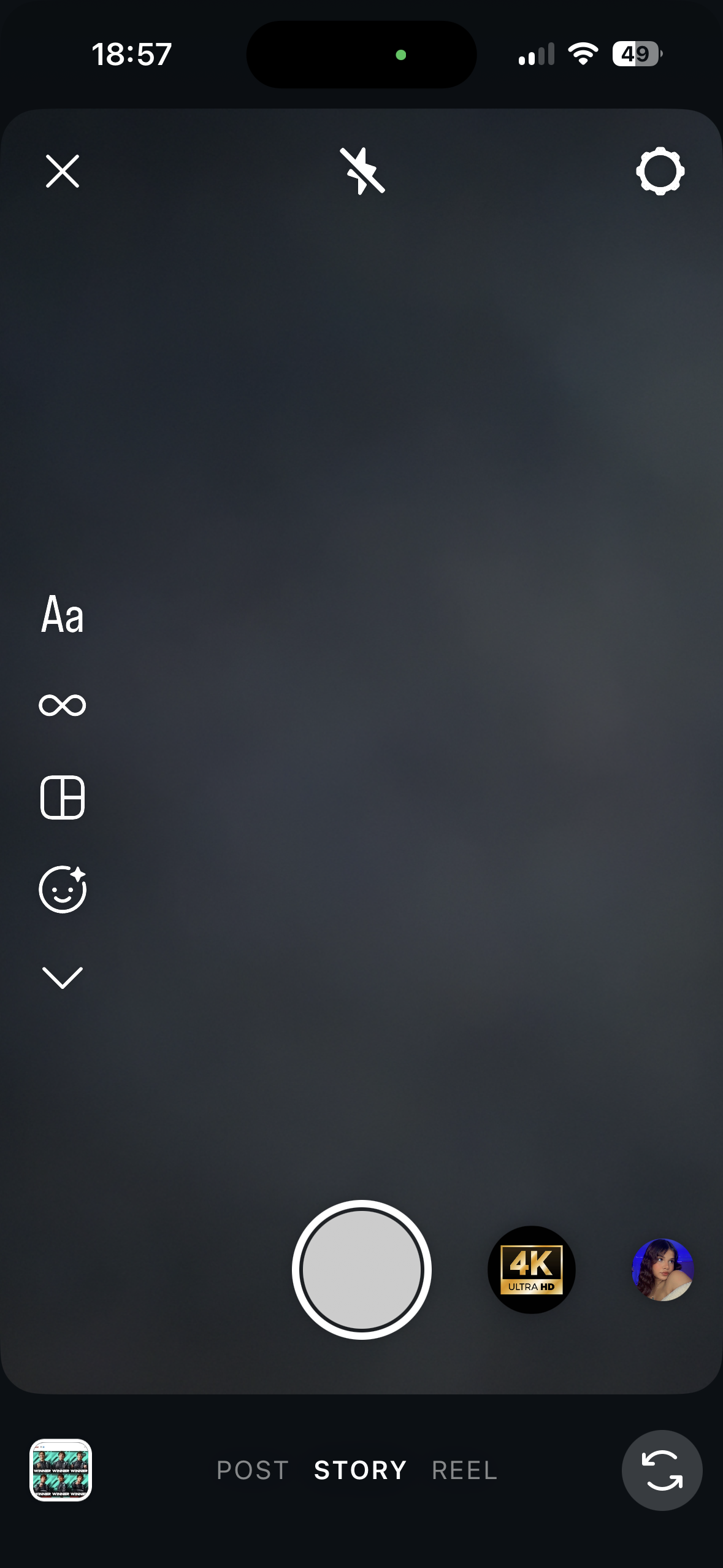 Instagram-style story camera interface in dark mode with capture button, camera flip, flash off, settings, and story/post/reel mode selector.