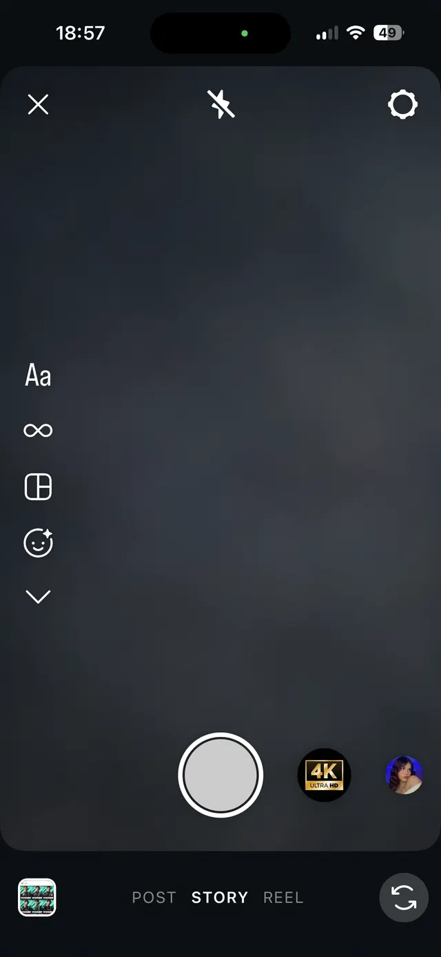 Instagram-style story camera interface in dark mode with capture button, camera flip, flash off, settings, and story/post/reel mode selector.