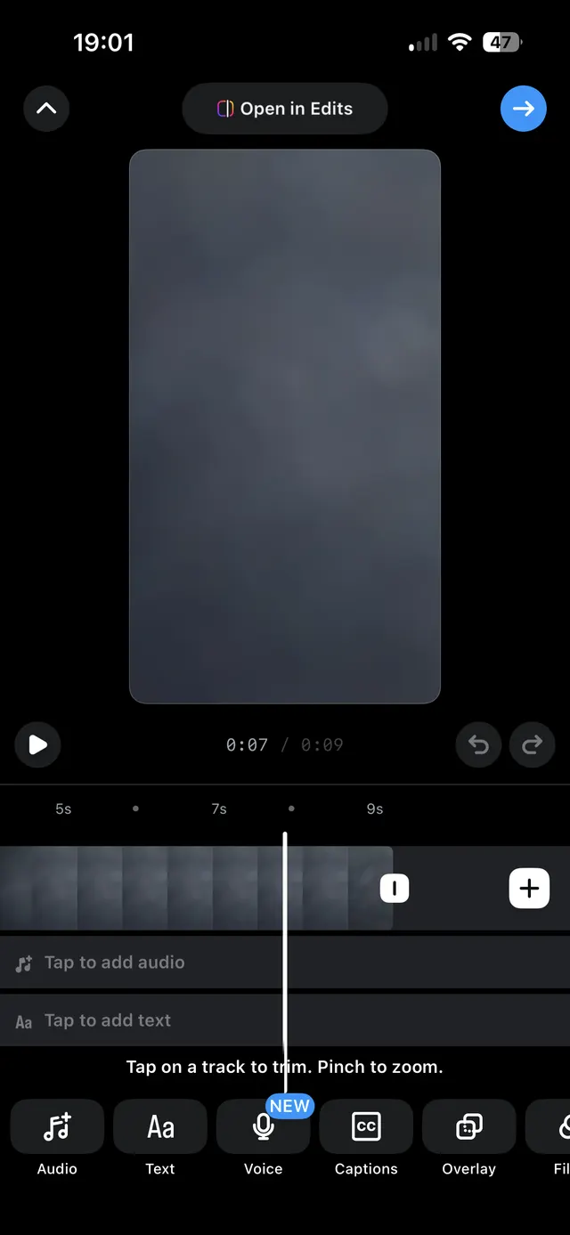 A mobile video editing screen with a preview canvas, play controls, a scrubber timeline with clips, and editing tools like audio, text, voice, captions, and overlay.