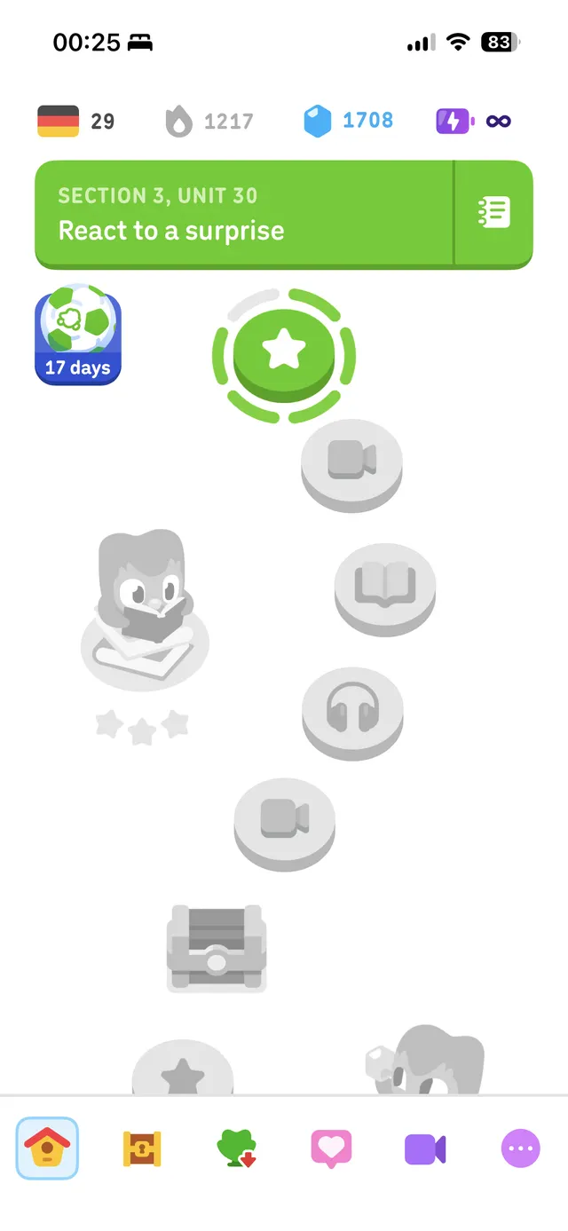 A mobile app screen showing a lesson path with nodes and a selected green lesson tile labeled 'Section 3, Unit 30 React to a surprise', progress/streak counters at the top, and a bottom navigation bar.