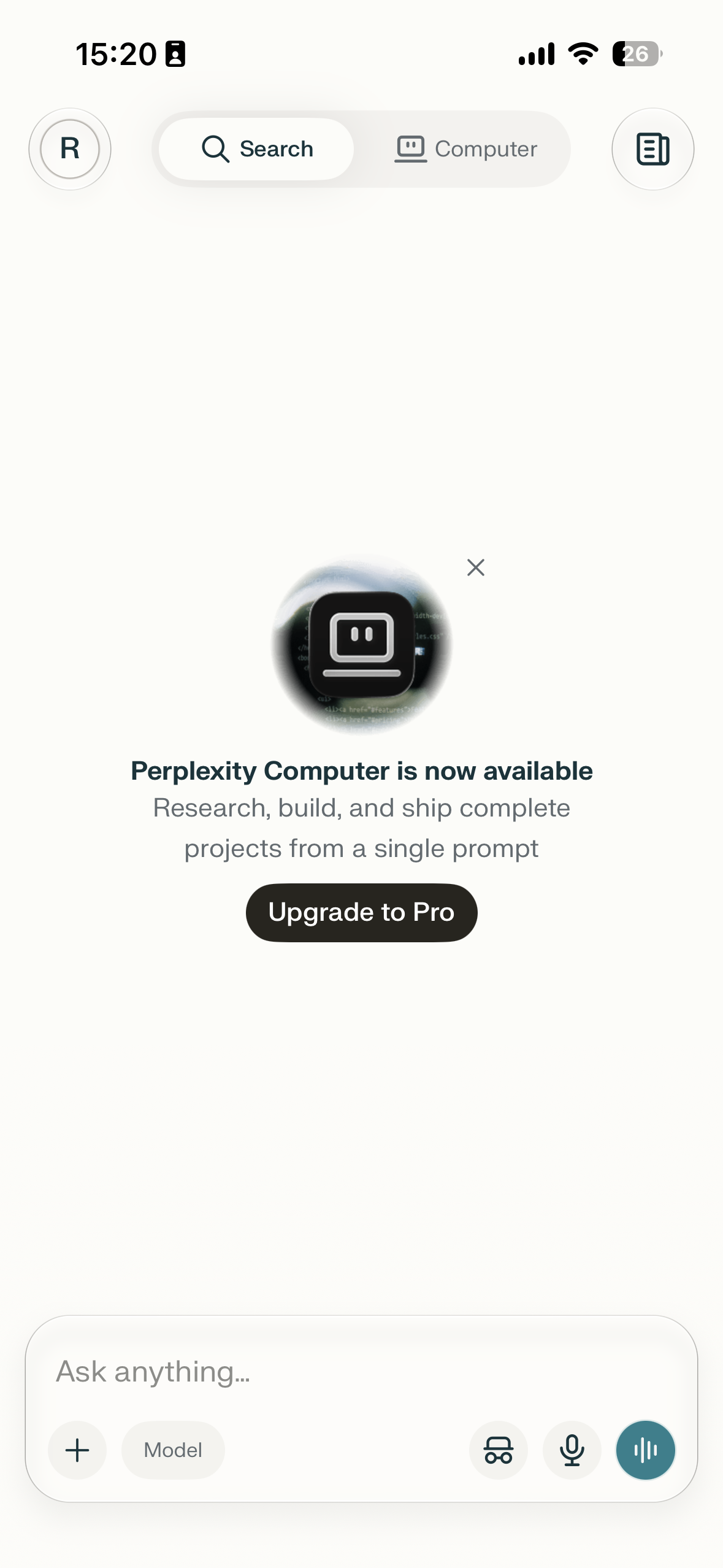 Mobile app screen with a centered promotional pop-up announcing Perplexity Computer availability, a close icon, and an Upgrade to Pro button over a chat composer interface.