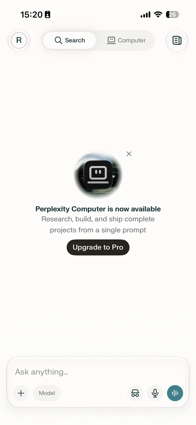 Mobile app screen with a centered promotional pop-up announcing Perplexity Computer availability, a close icon, and an Upgrade to Pro button over a chat composer interface.