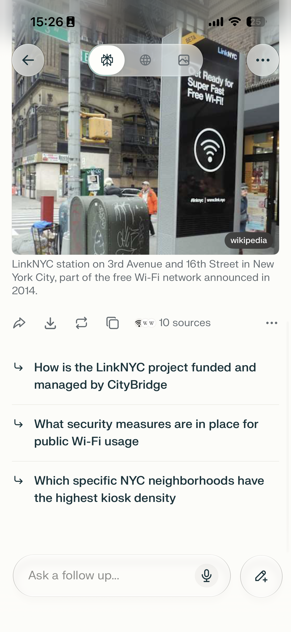 Mobile AI search result page showing a Wikipedia image and caption about a LinkNYC station, with related follow-up questions and an ask follow-up input at the bottom.