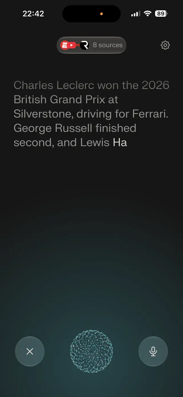 Dark mobile screen showing a voice assistant response with a large text answer, a sources pill near the top, settings gear, and bottom controls for cancel and microphone with a glowing orb in the center.